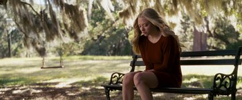 Movie still from “Dear John” (2010), directed by Lasse Hallström – A woman sitting on top of a bench in a park; Medium shot, Over the shoulder angle