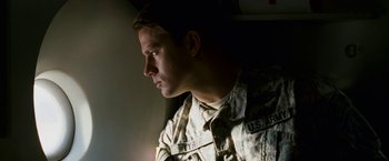 Movie still from “Dear John” (2010), directed by Lasse Hallström – A man in a military uniform looking off into the distance; Close Up shot, Low angle