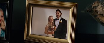 Movie still from “Dear John” (2010), directed by Lasse Hallström – A picture of a newly married couple in a gold frame; Extreme Close Up shot, High angle