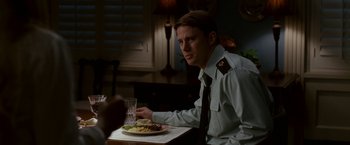 Movie still from “Dear John” (2010), directed by Lasse Hallström – A man sitting at a table with a plate of food in front of him; Close Up shot, Over the shoulder angle