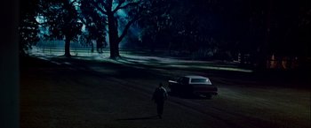 Movie still from “Dear John” (2010), directed by Lasse Hallström – A man walking on a path in a park at night; Extreme Wide shot, High angle