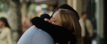 Movie still from “Dear John” (2010), directed by Lasse Hallström – A woman hugging another woman with her arms wrapped around her shoulder; Close Up shot, Over the shoulder angle