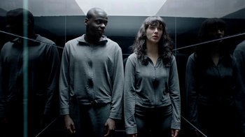 Movie still from “Black Mirror” (2011), created by Charlie Brooker – A man and a woman standing next to each other in front of a mirror; Medium shot, Overhead angle