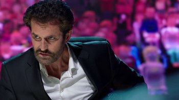 Movie still from “Black Mirror” (2011), created by Charlie Brooker – A person wearing a suit and tie; Close Up shot, Over the shoulder angle