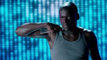 Movie still from “Black Mirror” (2011), created by Charlie Brooker – A man brushing his teeth while holding a cell phone; Close Up shot, Low angle