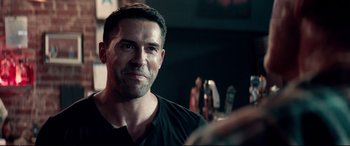 Movie still from “Debt Collectors” (2020), directed by Jesse V. Johnson – A person wearing a black t - shirt; Close Up shot, Over the shoulder angle