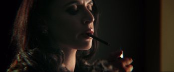 Movie still from “Debt Collectors” (2020), directed by Jesse V. Johnson – A person holding a cigarette in her mouth; Close Up shot, Low angle