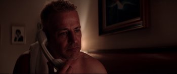 Movie still from “Debt Collectors” (2020), directed by Jesse V. Johnson – A person sitting in a room; Close Up shot, Over the shoulder angle