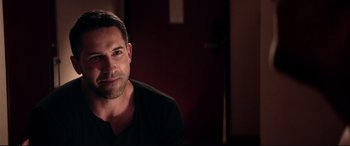 Movie still from “Debt Collectors” (2020), directed by Jesse V. Johnson – A person sitting in a room; Close Up shot, Over the shoulder angle