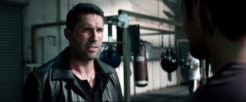 Movie still from “Debt Collectors” (2020), directed by Jesse V. Johnson – A person in a boxing ring; Close Up shot, Over the shoulder angle