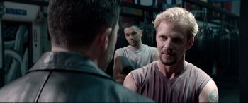 Movie still from “Debt Collectors” (2020), directed by Jesse V. Johnson – A man with blonde hair is looking at another man in the mirror; Close Up shot, Over the shoulder angle