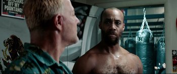 Movie still from “Debt Collectors” (2020), directed by Jesse V. Johnson – A man looking at himself in the mirror; Close Up shot, Over the shoulder angle