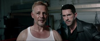 Movie still from “Debt Collectors” (2020), directed by Jesse V. Johnson – A man and a man standing next to each other; Close Up shot, High angle