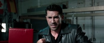 Movie still from “Debt Collectors” (2020), directed by Jesse V. Johnson – A person wearing a leather jacket; Close Up shot, High angle