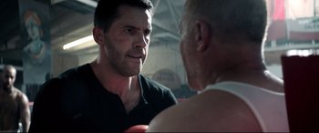 Movie still from “Debt Collectors” (2020), directed by Jesse V. Johnson – A man in a boxing ring talking to another man in a boxing ring; Close Up shot, Over the shoulder angle