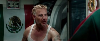 Movie still from “Debt Collectors” (2020), directed by Jesse V. Johnson – A person wearing a tank top; Close Up shot, Low angle