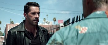 Movie still from “Debt Collectors” (2020), directed by Jesse V. Johnson – A person standing next to a fence; Close Up shot, Over the shoulder angle
