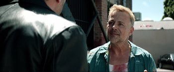 Movie still from “Debt Collectors” (2020), directed by Jesse V. Johnson – A man in a green jacket talking to another man in a white shirt; Close Up shot, Over the shoulder angle