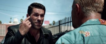 Movie still from “Debt Collectors” (2020), directed by Jesse V. Johnson – A man talking to another man in front of a fence; Close Up shot, Over the shoulder angle