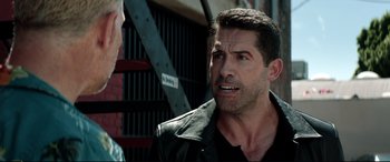 Movie still from “Debt Collectors” (2020), directed by Jesse V. Johnson – A man in a leather jacket talking to another man in a black shirt; Close Up shot, Over the shoulder angle