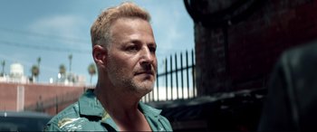 Movie still from “Debt Collectors” (2020), directed by Jesse V. Johnson – A person with a beard; Close Up shot, Low angle