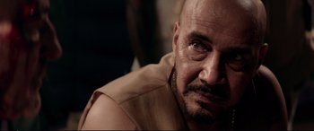 Movie still from “Debt Collectors” (2020), directed by Jesse V. Johnson – A person with a beard; Close Up shot, Over the shoulder angle