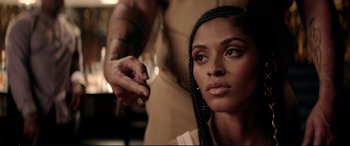 Movie still from “Debt Collectors” (2020), directed by Jesse V. Johnson – A woman sitting in front of a man holding a knife; Close Up shot, Over the shoulder angle