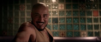 Movie still from “Debt Collectors” (2020), directed by Jesse V. Johnson – A man with a shaved head and a beard; Close Up shot, Over the shoulder angle