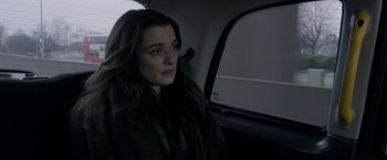 Movie still from “Disobedience” (2017), directed by Sebastián Lelio – A woman sitting in the back seat of a car; Close Up shot, Over the shoulder angle