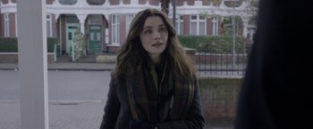 Movie still from “Disobedience” (2017), directed by Sebastián Lelio – A woman with long brown hair wearing a coat and a scarf; Close Up shot, Over the shoulder angle