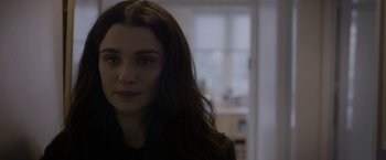 Movie still from “Disobedience” (2017), directed by Sebastián Lelio – A person with long brown hair; Close Up shot, Over the shoulder angle