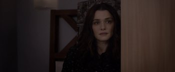 Movie still from “Disobedience” (2017), directed by Sebastián Lelio – A person with long dark hair; Close Up shot, Over the shoulder angle