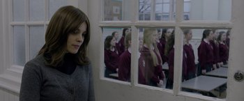 Movie still from “Disobedience” (2017), directed by Sebastián Lelio – A woman standing in front of a group of girls; Medium shot, Over the shoulder angle