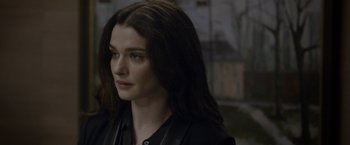 Movie still from “Disobedience” (2017), directed by Sebastián Lelio – A person with long dark hair; Close Up shot, Over the shoulder angle