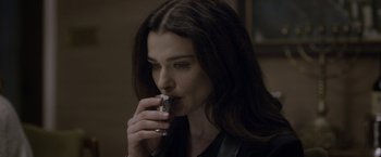 Movie still from “Disobedience” (2017), directed by Sebastián Lelio – A woman is drinking a beverage from a can; Close Up shot, Over the shoulder angle