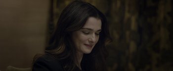 Movie still from “Disobedience” (2017), directed by Sebastián Lelio – A person with long dark hair; Close Up shot, Over the shoulder angle