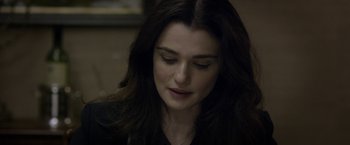 Movie still from “Disobedience” (2017), directed by Sebastián Lelio – A person with long dark hair; Close Up shot, Over the shoulder angle