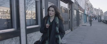 Movie still from “Disobedience” (2017), directed by Sebastián Lelio – A woman walking down the street holding a purse; Medium shot, Over the shoulder angle