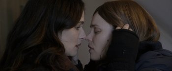 Movie still from “Disobedience” (2017), directed by Sebastián Lelio – Two women face to face with one of them touching the other's face; Close Up shot, Over the shoulder angle