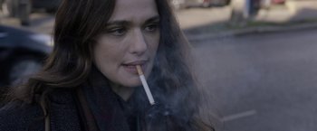 Movie still from “Disobedience” (2017), directed by Sebastián Lelio – A person smoking a cigarette; Close Up shot, Over the shoulder angle