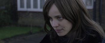 Movie still from “Disobedience” (2017), directed by Sebastián Lelio – A person with long hair; Close Up shot, Over the shoulder angle