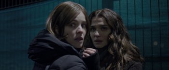 Movie still from “Disobedience” (2017), directed by Sebastián Lelio – Two young women standing next to each other; Close Up shot, Over the shoulder angle
