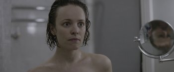 Movie still from “Disobedience” (2017), directed by Sebastián Lelio – A person with wet hair in a room; Close Up shot, Over the shoulder angle