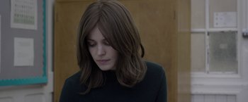 Movie still from “Disobedience” (2017), directed by Sebastián Lelio – A person with long hair; Close Up shot, Over the shoulder angle