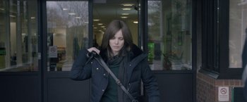 Movie still from “Disobedience” (2017), directed by Sebastián Lelio – A woman in a black jacket holding onto a bag; Medium shot, Over the shoulder angle