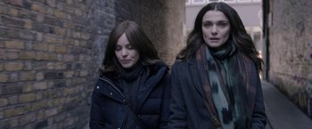 Movie still from “Disobedience” (2017), directed by Sebastián Lelio – Two women walking down a street in winter clothes; Close Up shot, Over the shoulder angle