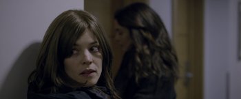 Movie still from “Disobedience” (2017), directed by Sebastián Lelio – A woman sitting in front of another woman in a room; Close Up shot, Over the shoulder angle