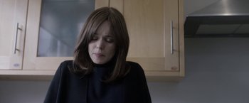 Movie still from “Disobedience” (2017), directed by Sebastián Lelio – A woman in a black shirt is sitting in a kitchen; Close Up shot, Over the shoulder angle
