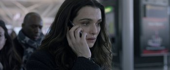 Movie still from “Disobedience” (2017), directed by Sebastián Lelio – A woman talking on a cell phone while wearing a sweater; Close Up shot, High angle