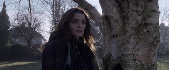 Movie still from “Disobedience” (2017), directed by Sebastián Lelio – A woman standing next to a tree in a forest; Close Up shot, Over the shoulder angle